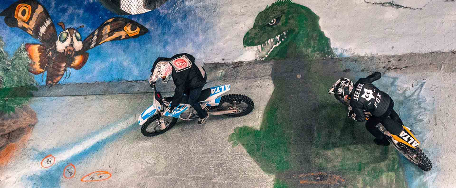 Andy with See See friend Jimmy Hill freestyle motocrosser riding steep slope with Godzilla at Burnside skate park in Portland, Oregon
