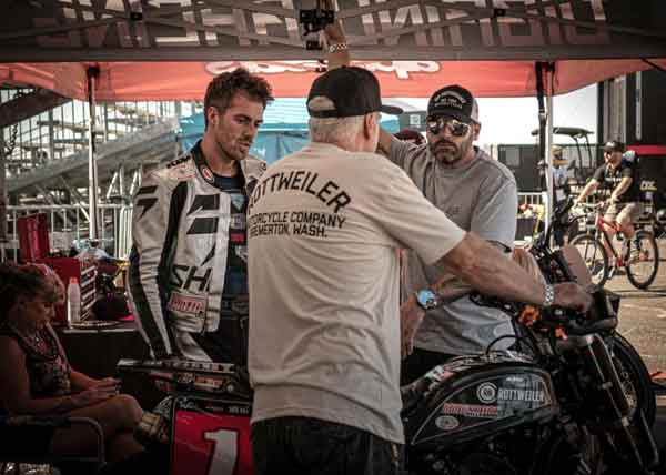 Andy DiBrino at RSD Super Hooligan series finale Moto Beach Classic working on his motorcycle prep with his Dad Kieth, EDR of EDR Performance, and his Mom.