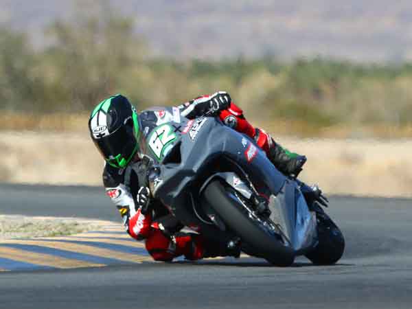 Oregon's own Andy DiBrino on his Kawasaki Oregon Motorcycle Attorney backed stock 1000 motorcycle at MotoAmerica Laguna Seca popping a wheelie.