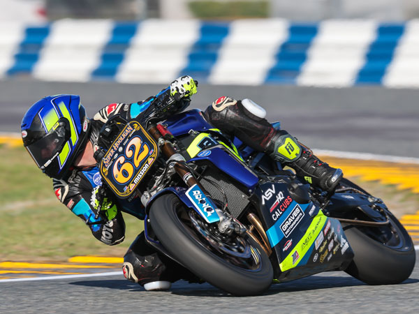 Andy DiBrino pictured on his BPR Racing Yamaha MT-09 at Daytona going fast and dragging his knee around a turn at Daytona Super Hooligans first races of MotoAmerica series for the year