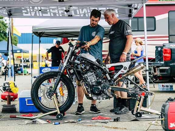 Andy DiBrino and his Dad Keith working on the KTM Duke at the RSD Superhooligan National Champ series Round 4 after an emergency issue with the bike