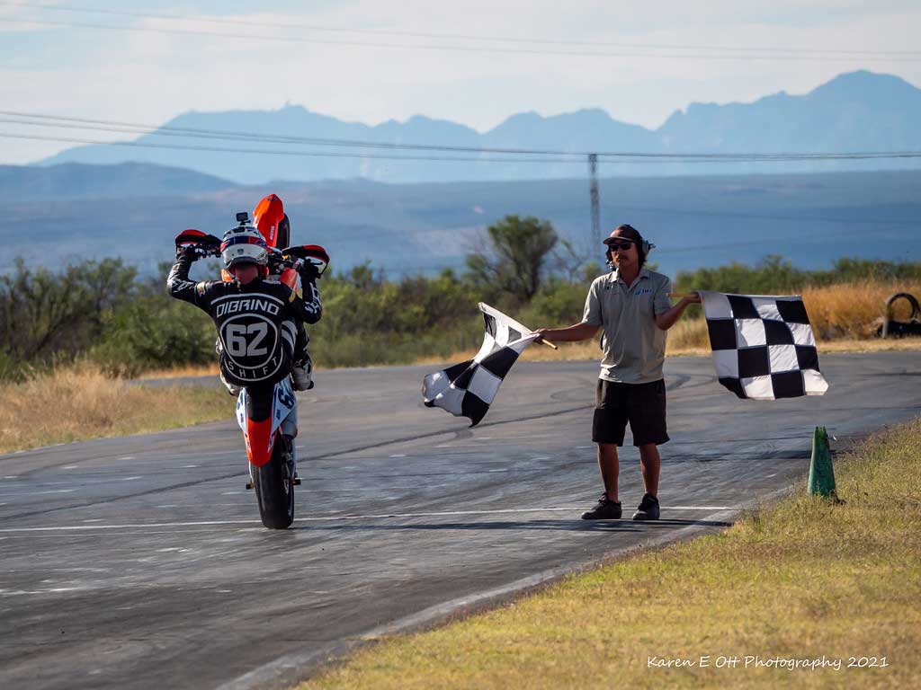 Andy DiBrino at the finish with a wheelie on his KTM motorcycle